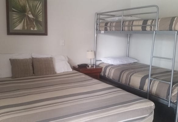 Double bed and bunk bed in a family room at Tweed River Motel
